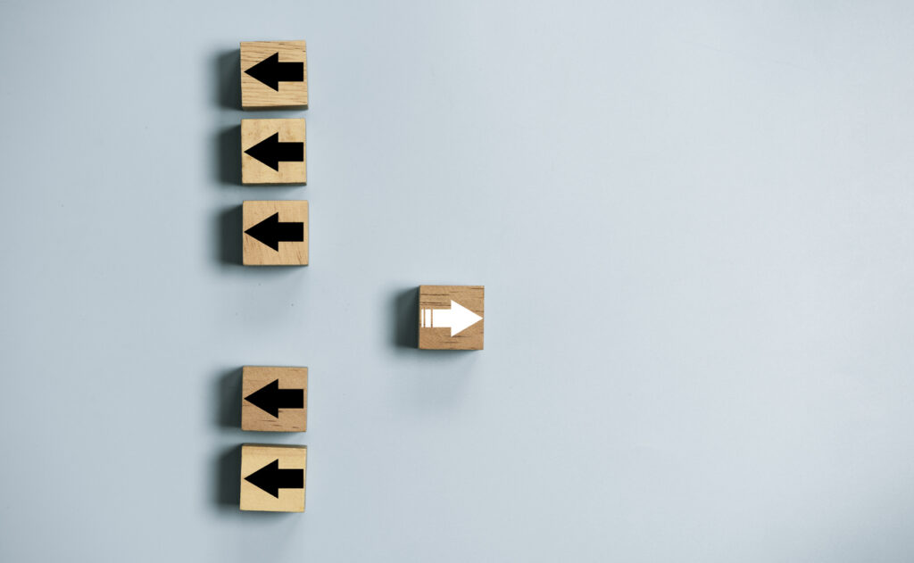 A group of wooden arrows pointing in different directions and data discrepancies.